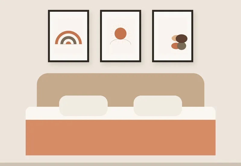 Three framed boho prints above a bed: a terracotta rainbow, a sun and pebbles